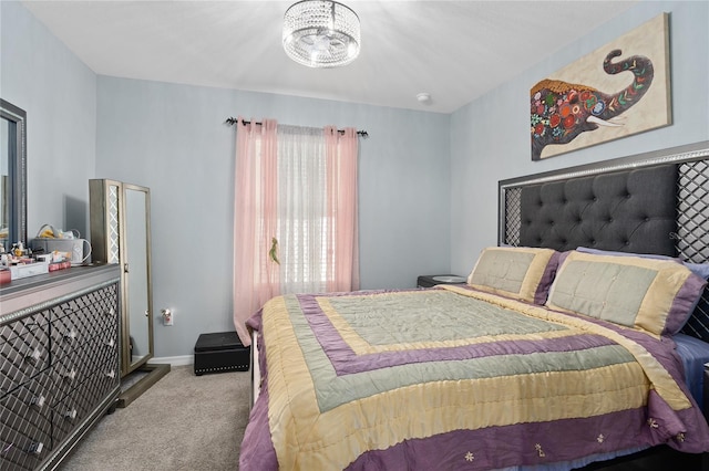 bedroom featuring carpet and a notable chandelier