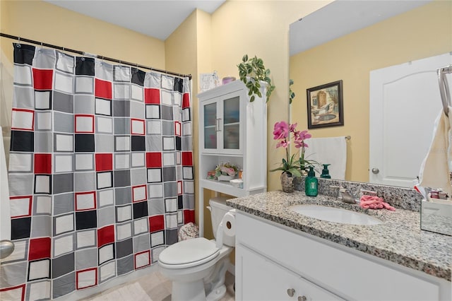 bathroom with tile patterned floors, vanity, and toilet