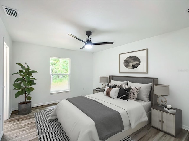 bedroom with ceiling fan and wood-type flooring