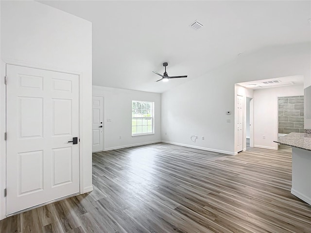 unfurnished living room with ceiling fan and dark hardwood / wood-style floors