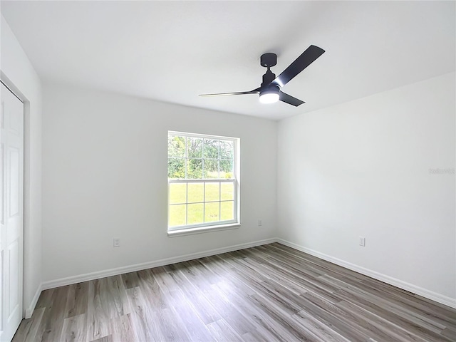 spare room with ceiling fan and light hardwood / wood-style flooring