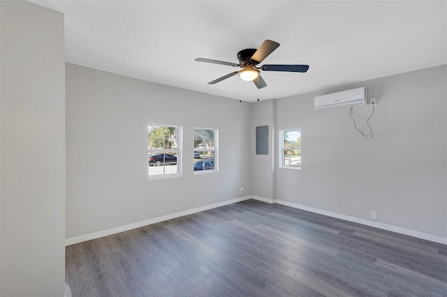 empty room featuring electric panel, dark hardwood / wood-style floors, a wall mounted AC, and ceiling fan