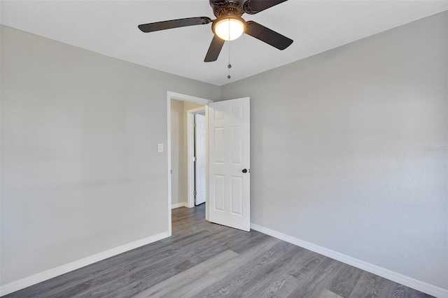 empty room featuring ceiling fan and hardwood / wood-style floors