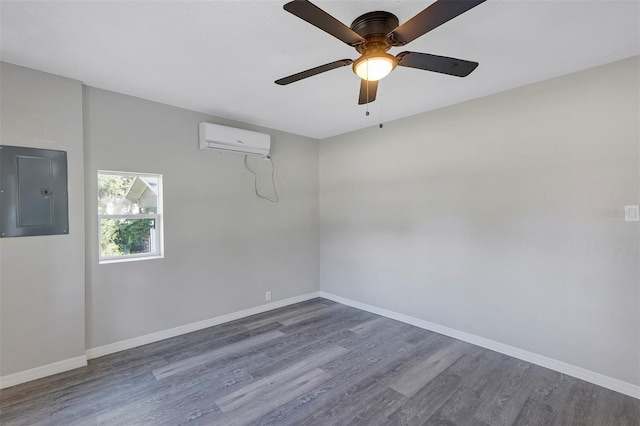 empty room featuring dark hardwood / wood-style floors, ceiling fan, electric panel, and a wall mounted AC