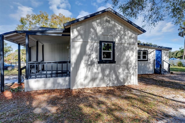 view of side of home with covered porch