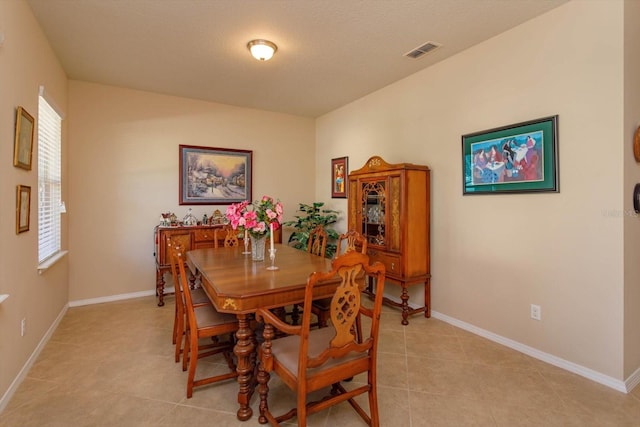 dining room featuring light tile patterned floors and a textured ceiling