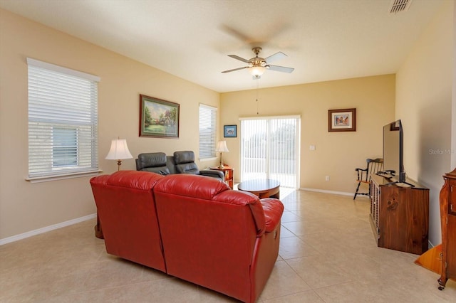 tiled living room featuring ceiling fan