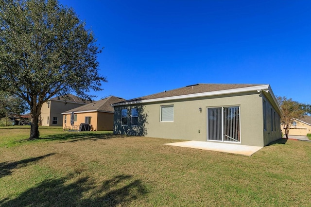 back of property with a patio area and a yard