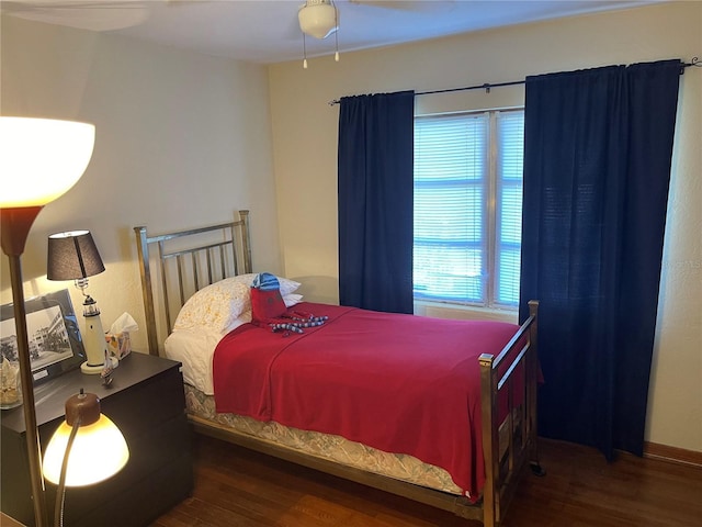 bedroom featuring multiple windows, ceiling fan, and dark wood-type flooring