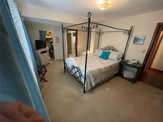 carpeted bedroom featuring an inviting chandelier