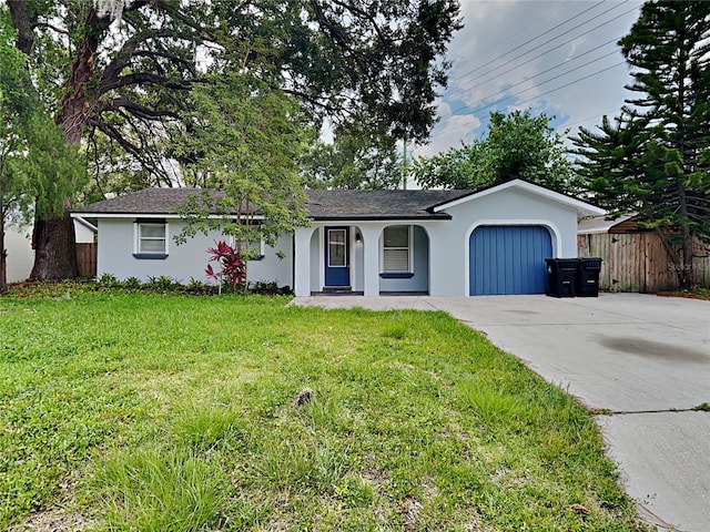 ranch-style house with a front yard and a garage