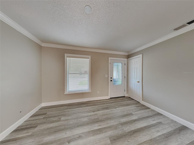 entryway featuring ornamental molding, a textured ceiling, and light hardwood / wood-style flooring