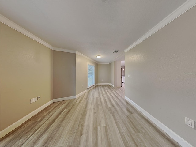 unfurnished room with light hardwood / wood-style flooring and ornamental molding