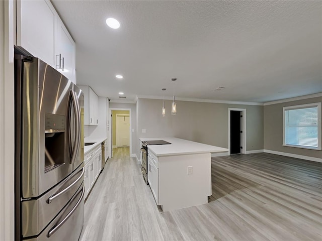 kitchen with crown molding, light hardwood / wood-style floors, pendant lighting, white cabinets, and appliances with stainless steel finishes