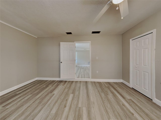 unfurnished bedroom with ceiling fan and light hardwood / wood-style flooring