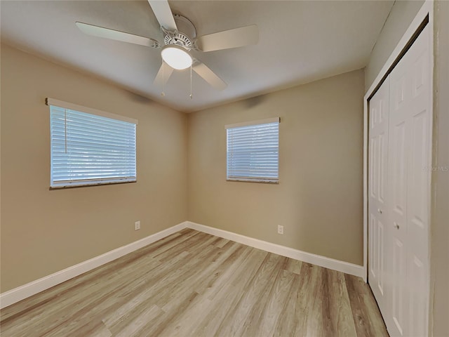 unfurnished bedroom featuring ceiling fan, a closet, and light hardwood / wood-style flooring