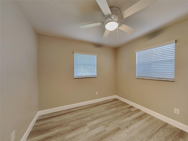 unfurnished room with a wealth of natural light, light hardwood / wood-style flooring, and ceiling fan