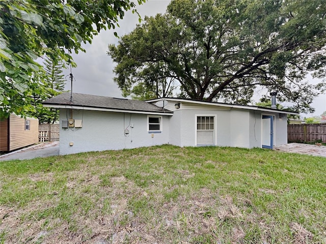 back of house featuring a lawn