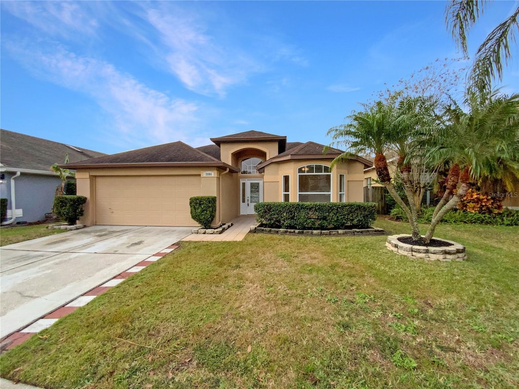 view of front of house with a front lawn and a garage