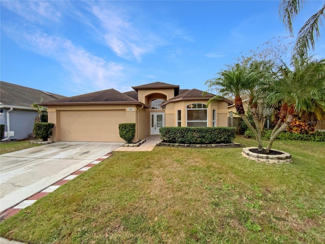 view of front of house with a front lawn and a garage