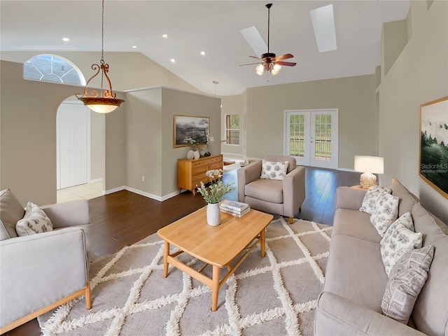 living room featuring wood-type flooring, french doors, high vaulted ceiling, and ceiling fan