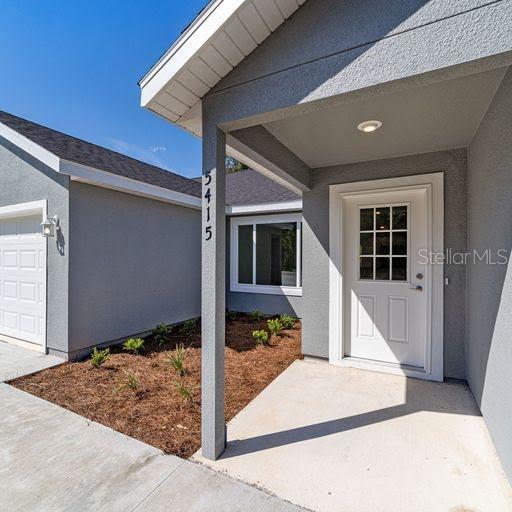 doorway to property with a garage