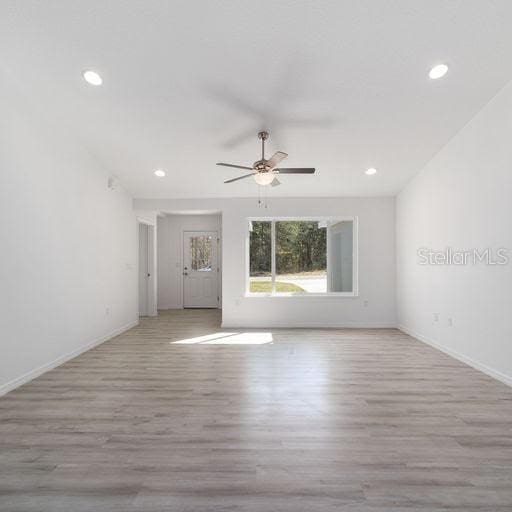 unfurnished room featuring ceiling fan and light hardwood / wood-style flooring