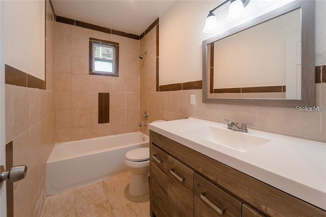 bathroom with toilet, shower / washtub combination, tile walls, and vanity