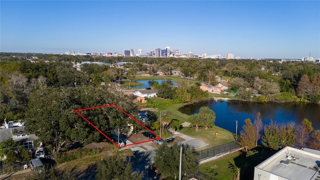 birds eye view of property with a water view and a city view