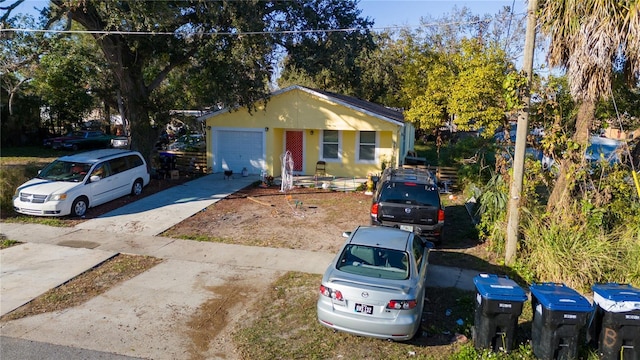 single story home with an attached garage and concrete driveway