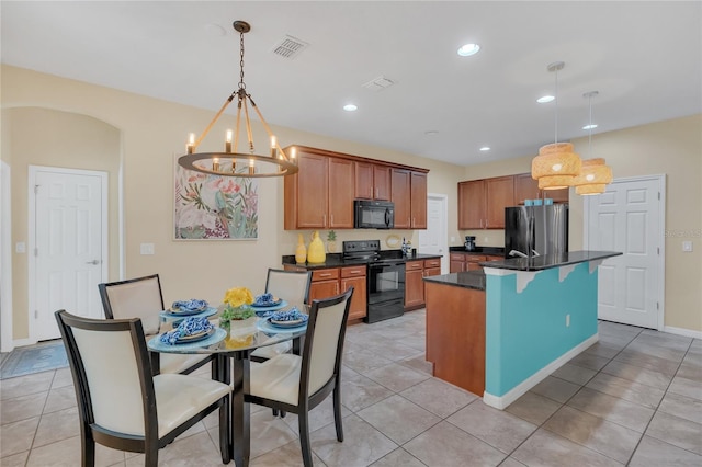 kitchen featuring pendant lighting, light tile patterned floors, black appliances, and a kitchen island