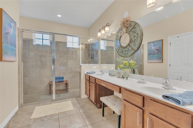 bathroom featuring walk in shower, vanity, and tile patterned flooring