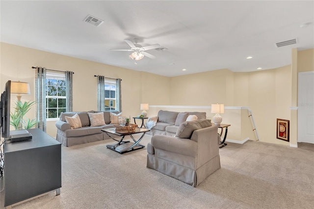 carpeted living room featuring ceiling fan