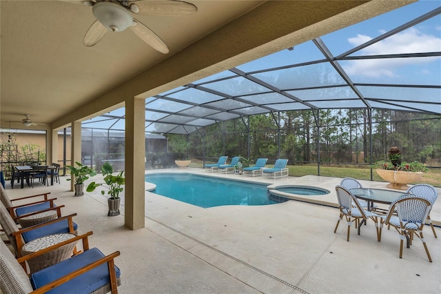 view of swimming pool featuring a lanai, a patio, and an in ground hot tub