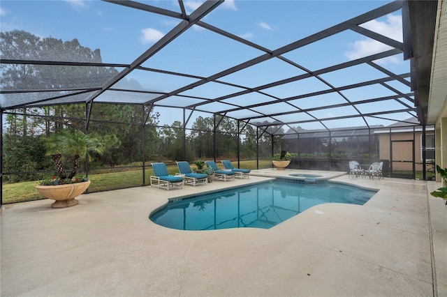 view of pool with a patio area, an in ground hot tub, and glass enclosure