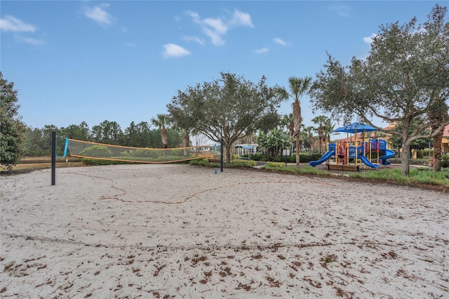 exterior space with a playground and volleyball court