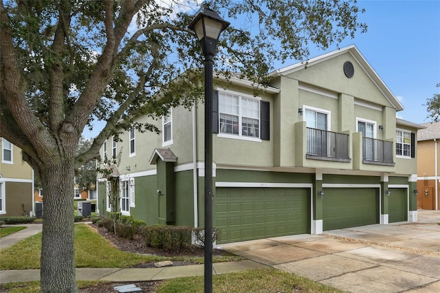 multi unit property featuring a garage and a balcony