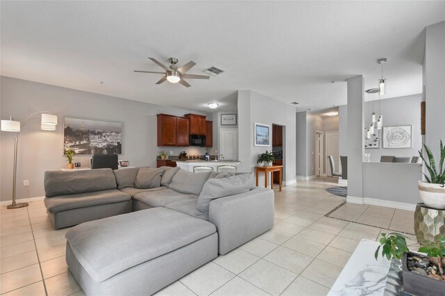 tiled living room with ceiling fan