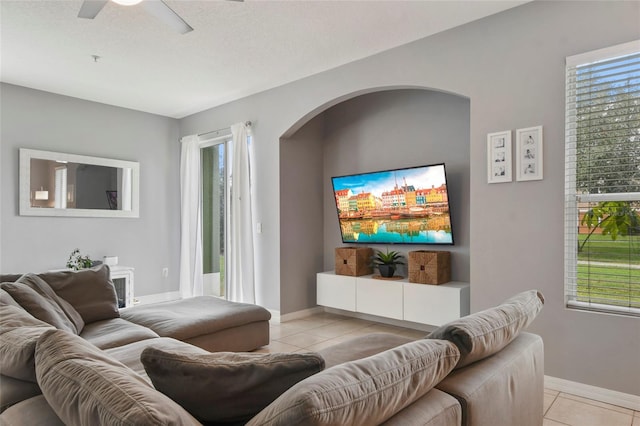 living room featuring light tile patterned floors and ceiling fan