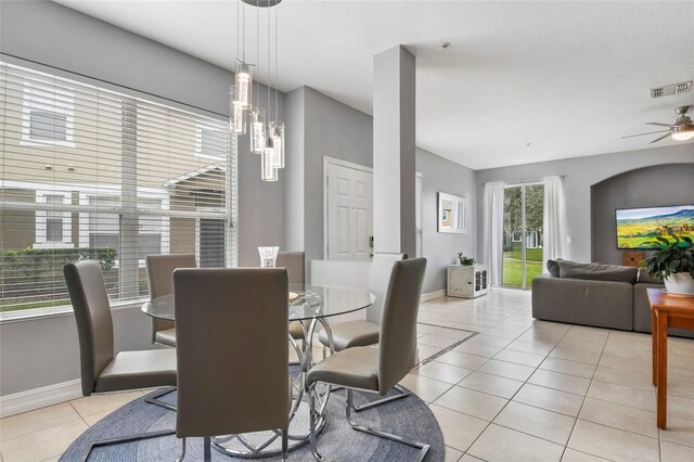 tiled dining room featuring ceiling fan and a healthy amount of sunlight