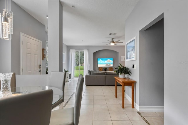 living room featuring light tile patterned floors and ceiling fan