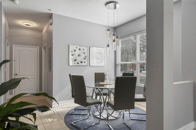 tiled dining area with a chandelier