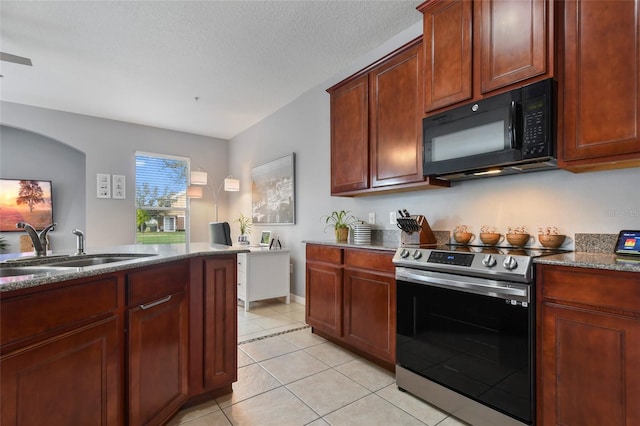 kitchen with a textured ceiling, sink, light tile patterned floors, and stainless steel range with electric stovetop