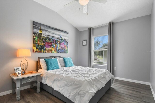 bedroom featuring ceiling fan, dark hardwood / wood-style floors, and lofted ceiling