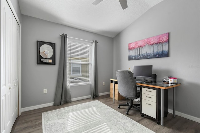 office area featuring dark hardwood / wood-style floors, ceiling fan, lofted ceiling, and a textured ceiling