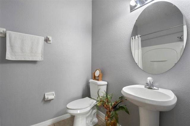 bathroom featuring tile patterned flooring and toilet