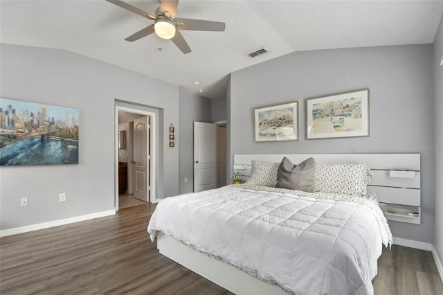 bedroom featuring connected bathroom, ceiling fan, dark hardwood / wood-style flooring, and vaulted ceiling