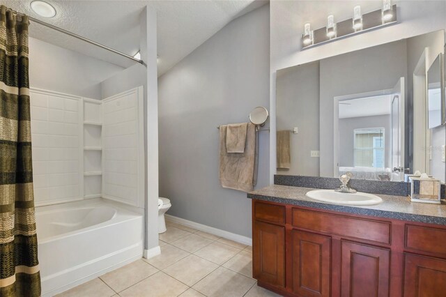 full bathroom with shower / bath combination with curtain, vanity, a textured ceiling, tile patterned flooring, and toilet