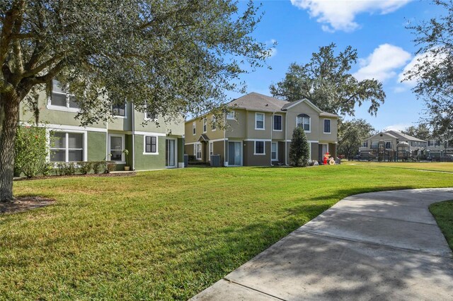 view of front of house featuring a front yard and cooling unit