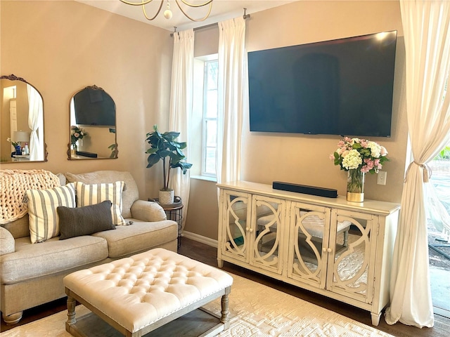 sitting room featuring wood-type flooring and an inviting chandelier